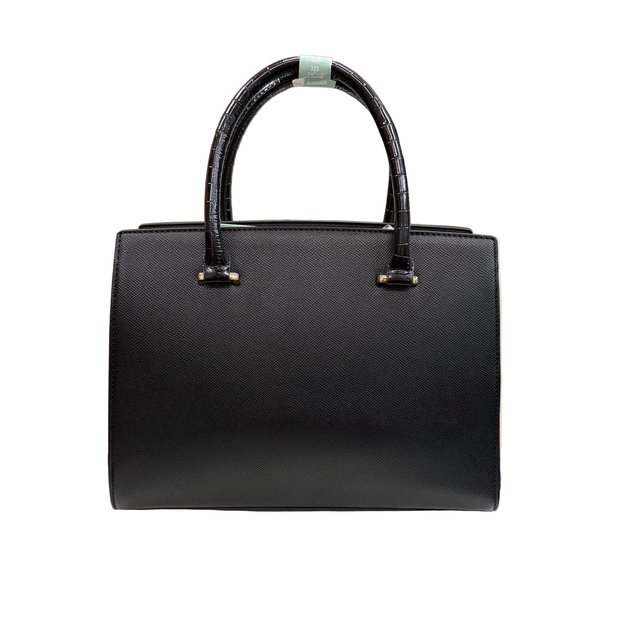 Black handbag on a white pedestal with other bags in the background