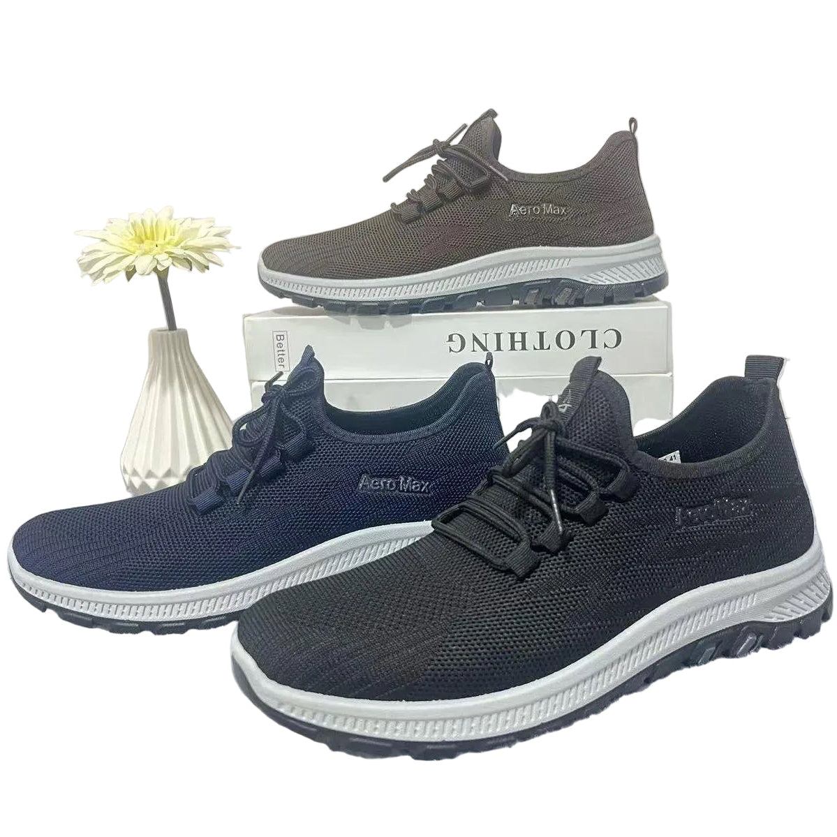 Three pairs of shoes in blue, gray, and navy on a white background with a small plant.