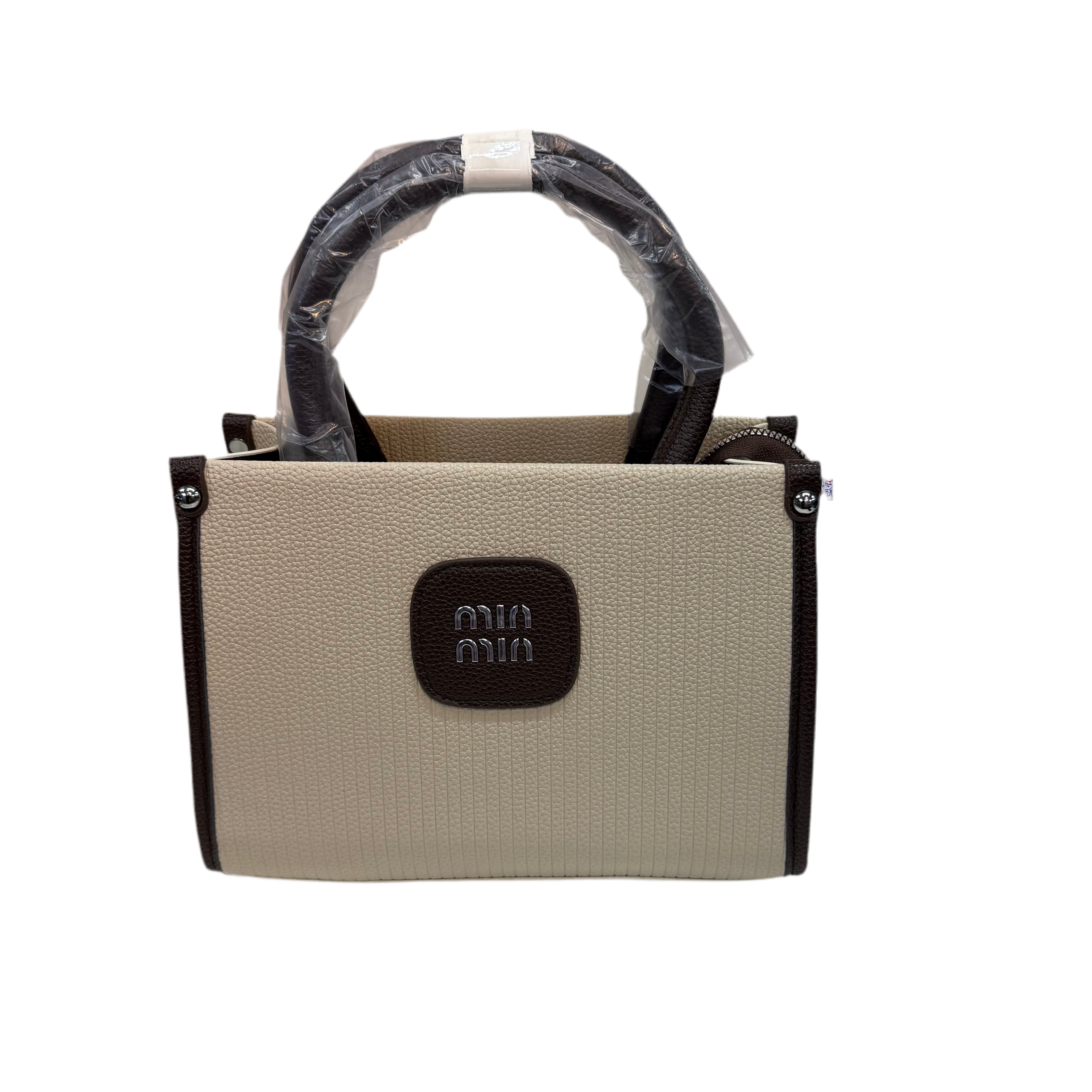 Beige handbag with black accents and a visible brand logo on a white background