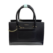 Black handbag with gold chain detail on a white background